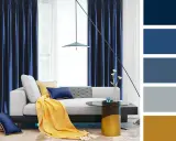Elegancki salon z granatowymi zasłonami, beżową kanapą i żółtym pledem. Paleta barw: beż z granatem.