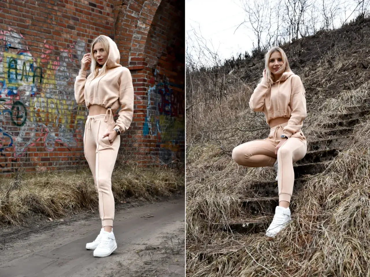 Kobieta w beżowym komplecie ze spodniami dresowymi i krótką bluzą z kapturem pozuje na tle ceglanej ściany z graffiti i na schodach porośniętych trawą.